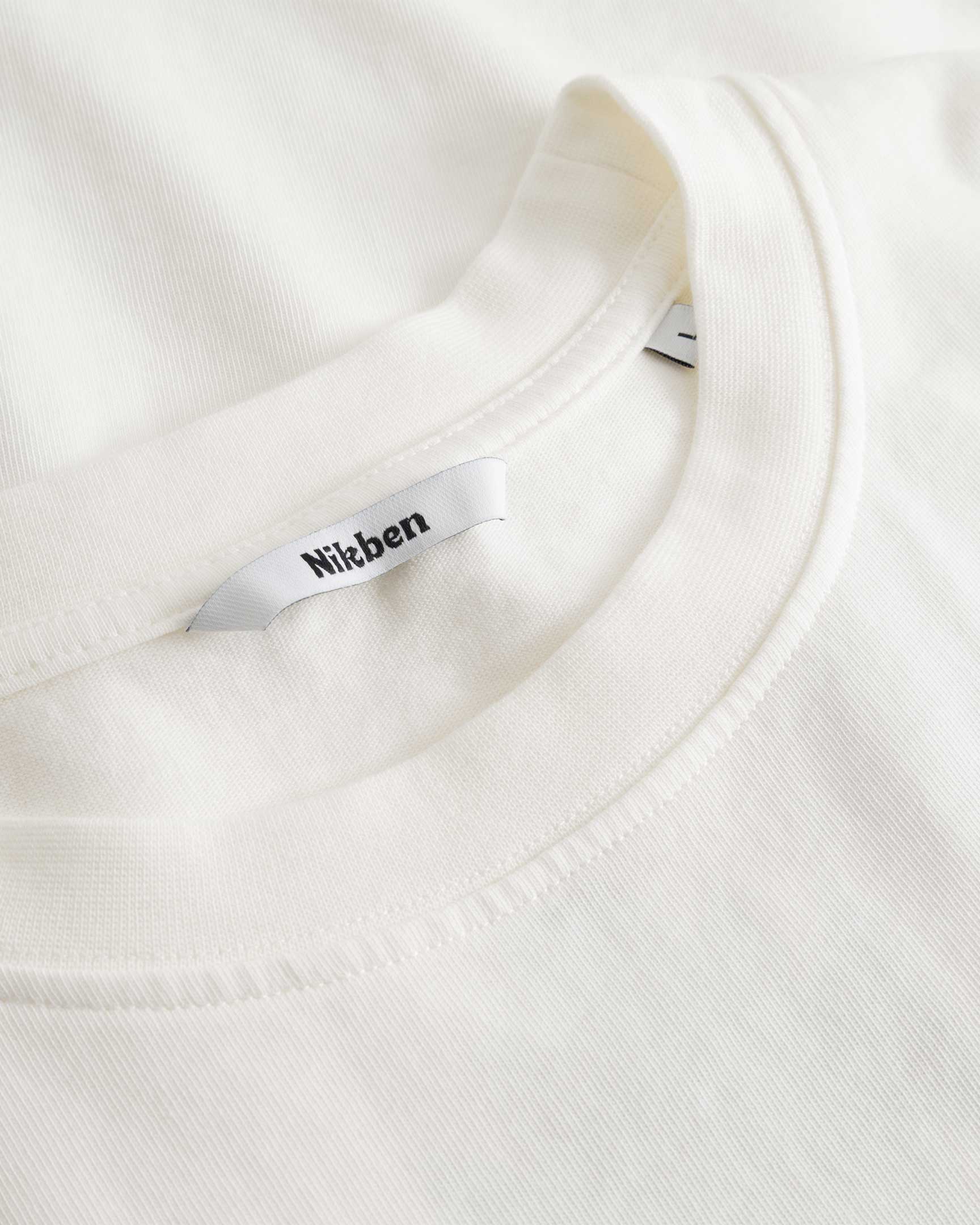 Closeup view of Nikben necklabel on white T-shirt