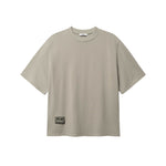 Beige T-shirt with green Nikben patch logo on the lower left side 