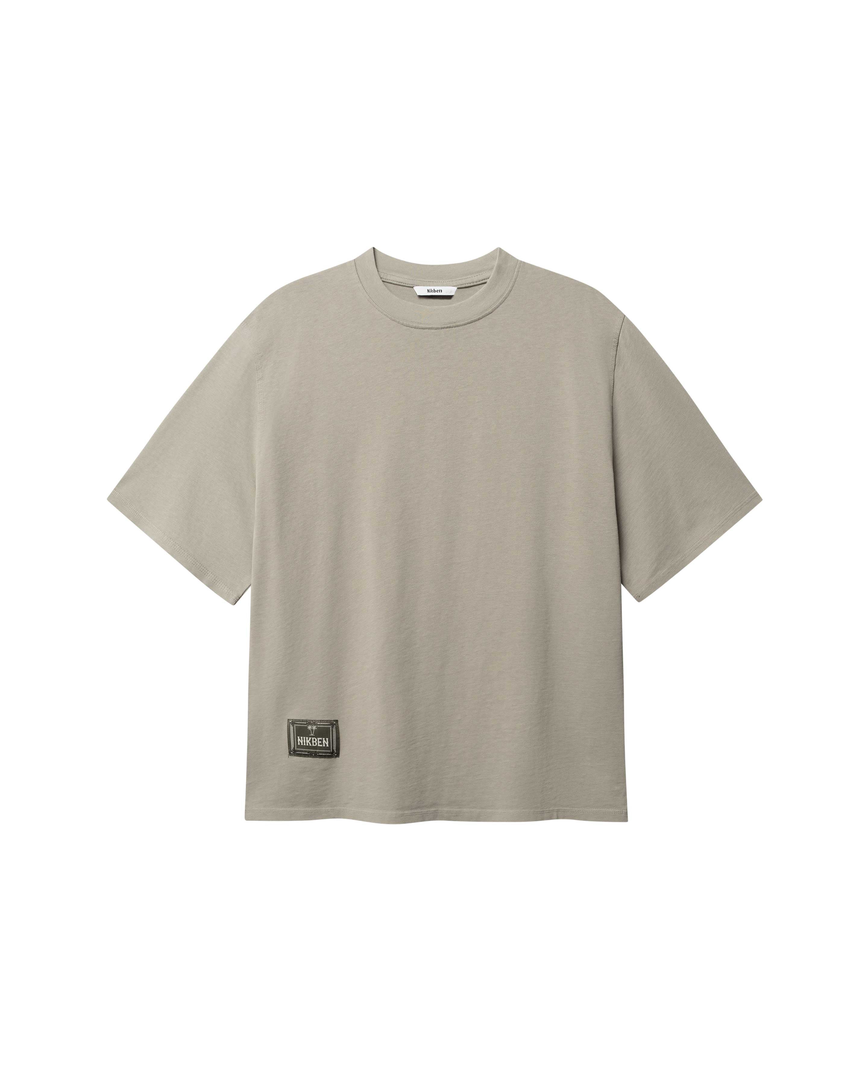Beige T-shirt with green Nikben patch logo on the lower left side 