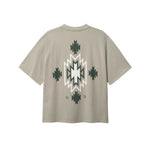 Back of beige T-shirt with native inspired print in green and white