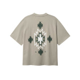 Back of beige T-shirt with native inspired print in green and white
