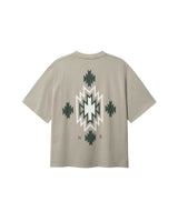 Back of beige T-shirt with native inspired print in green and white