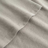 Closeup view of arm stitchings on beige T-shirt