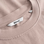 Closeup view of Nikben necklabel on beige T-shirt