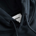 Closeup view of Nikben necklabel on black hoodie
