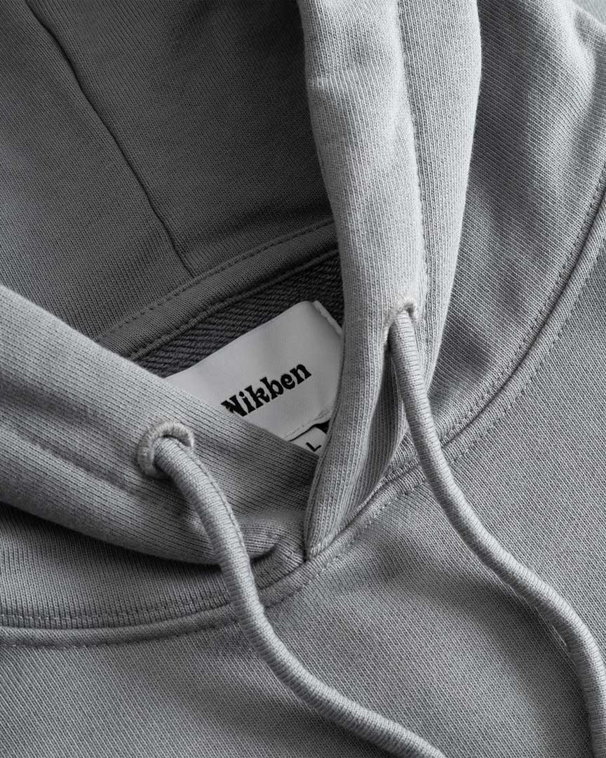 Closeup view of Nikben necklabel on grey hoodie