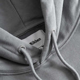 Closeup view of Nikben necklabel on grey hoodie
