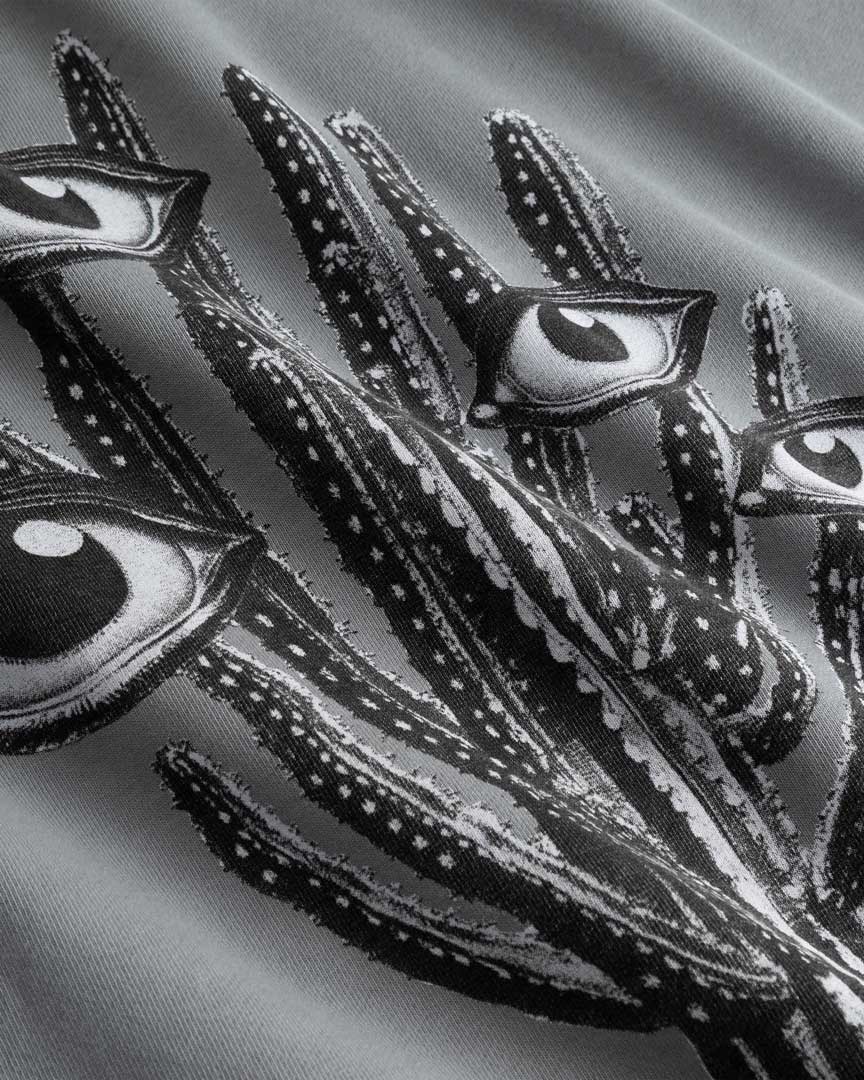 Closeup view of black and white cactus print on grey hoodie