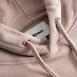 Closeup view of Nikben necklabel on brown hoodie
