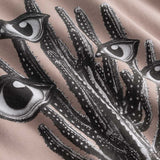 Closeup view of black and white cactus print on brown hoodie