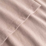 Closeup view of arm stitchings on brown T-shirt