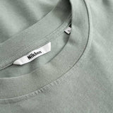 Closeup view of Nikben necklabel on green T-shirt
