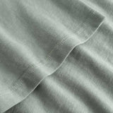 Closeup view of arm stitchings on green T-shirt