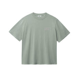 Green T-shirt with brown "BUENAS NOCHES" text print on chest