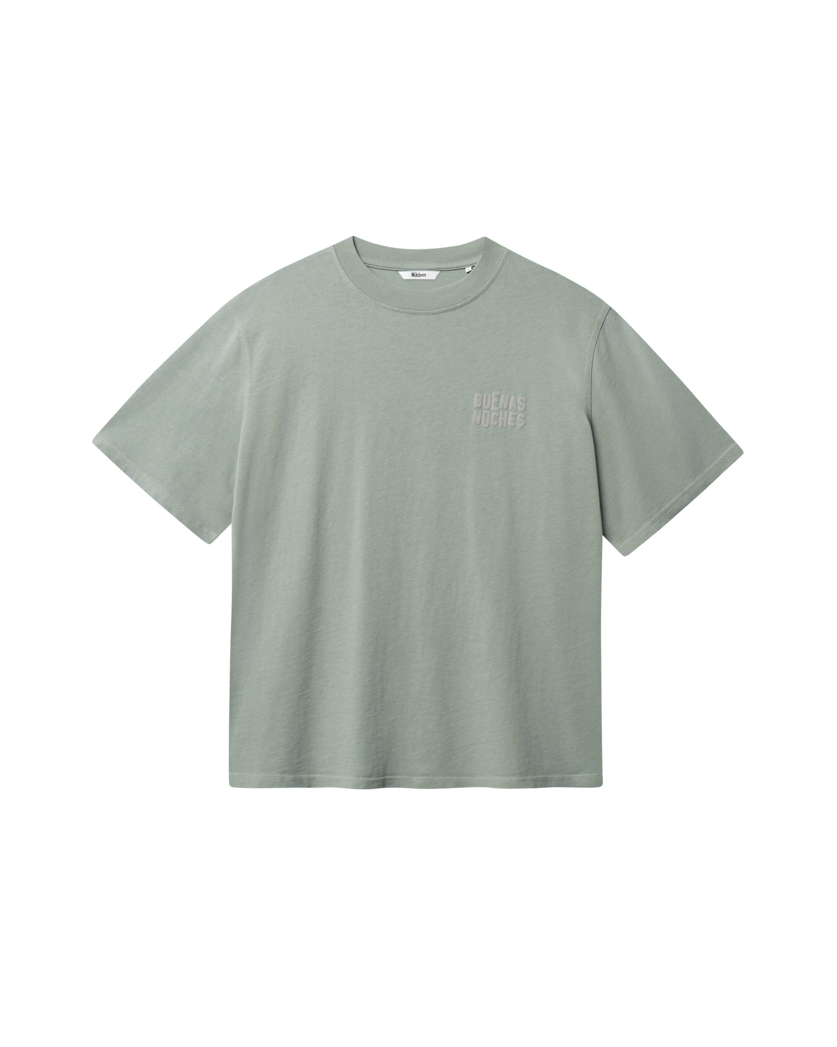 Green T-shirt with brown "BUENAS NOCHES" text print on chest