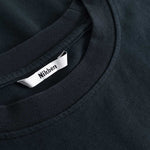 Closeup view of Nikben necklabel on black T-shirt