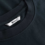 Closeup view of Nikben necklabel on black T-shirt