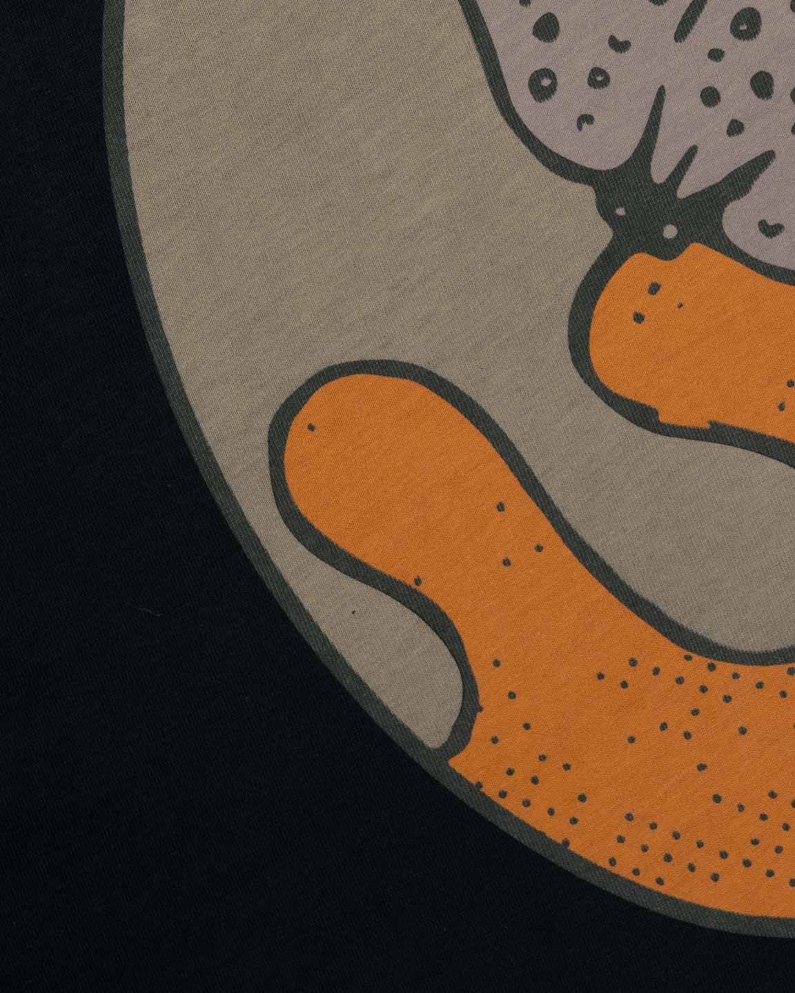 Closeup view of green and orange print on back of black T-shirt