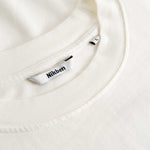 Closeup view of Nikben necklabel on white longsleeve T-shirt