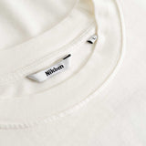 Closeup view of Nikben necklabel on white longsleeve T-shirt