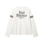 White longsleeve T-shirt with brown "JUST HOLIDAY" print on back and brown stripes on sleeves