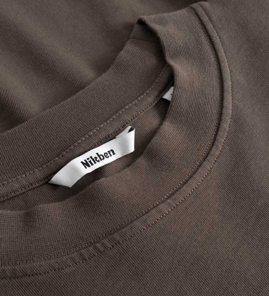 Closeup view of Nikben necklabel on brown longsleeve T-shirt