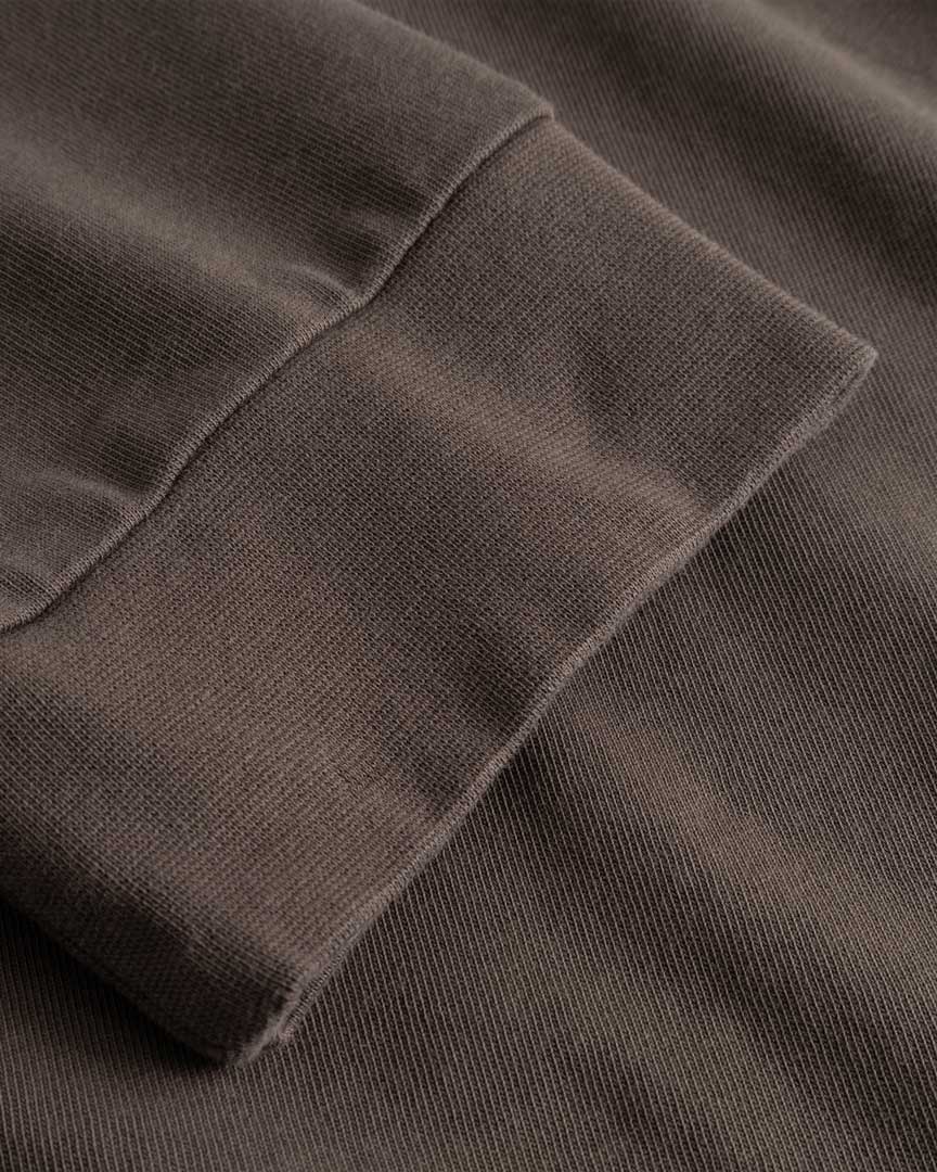Closeup view of cuffs on brown longsleeve T-shirt