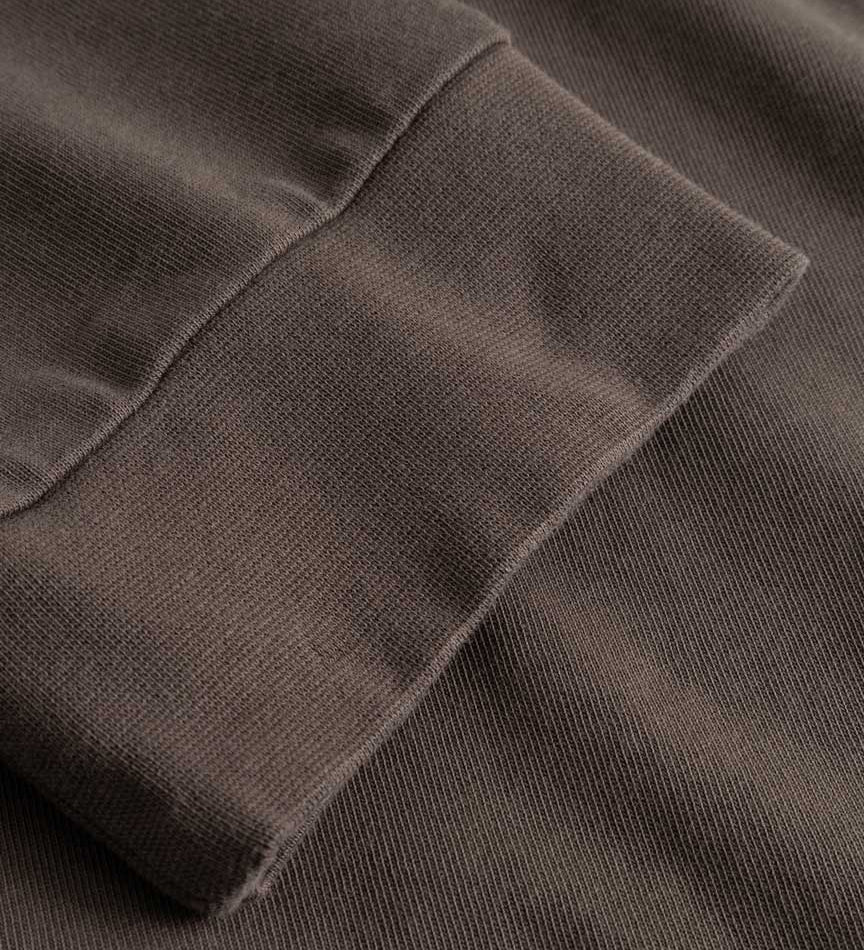Closeup view of cuffs on brown longsleeve T-shirt