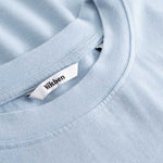 Closeup view of Nikben necklabel on light blue T-shirt