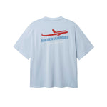 Back of light blue T-shirt with blue Nikben Airlines logo and red airplane print 