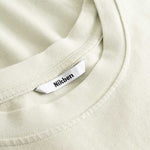 Closeup view of Nikben necklabel on light grey T-shirt