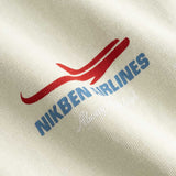 Closeup view of blue Nikben Airlines logo and red airplane print on light grey T-shirt