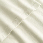 Closeup view of arm stitchings on light grey T-shirt