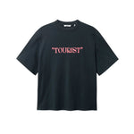 Black T-shirt with pink "TOURIST" print on the middle chest