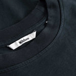 Closeup view of Nikben necklabel on black T-shirt