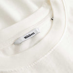 Closeup view of Nikben necklabel on white T-shirt