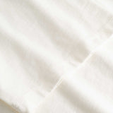 Closeup view of arm stitchings on white T-shirt