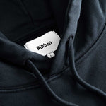 Closeup view of Nikben necklabel on black hoodie