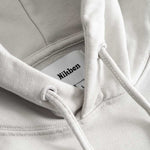 Closeup view of Nikben necklabel on gray hoodie