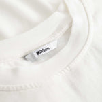 Closeup view of Nikben necklabel on white T-shirt