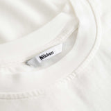 Closeup view of Nikben necklabel on white T-shirt