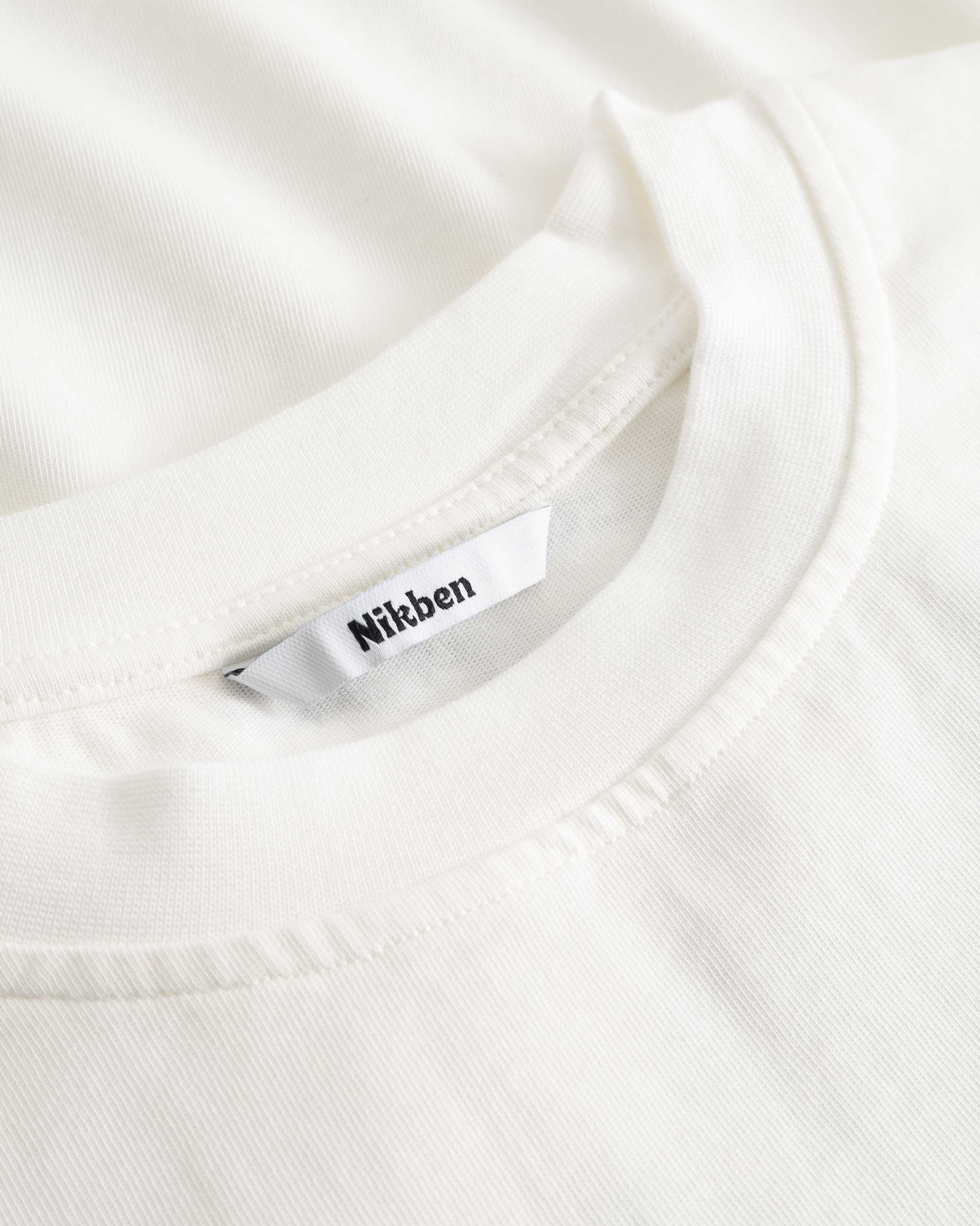 Closeup view of Nikben necklabel on white T-shirt