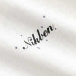 Closeup view of black Nikben logo on white T-shirt