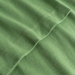 Closeup view of arm stitchings on green T-shirt