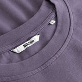 Closeup view of Nikben necklabel on purple T-shirt