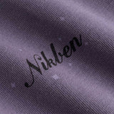 Closeup view of black Nikben logo on purple T-shirt