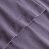 Closeup view of arm stitchings on purple T-shirt