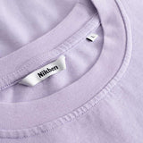 Closeup view of Nikben necklabel on light purple T-shirt