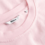 Closeup view of Nikben necklabel on light pink T-shirt