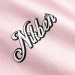 Closeup view of black and white Nikben logo on light pink T-shirt
